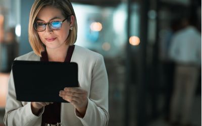 woman looking at her tablet for data analytics - Allston Yale