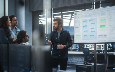 Man presenting information at a data analytics meeting - Allston Yale
