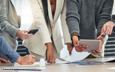 office workers sharing reports for data analytics