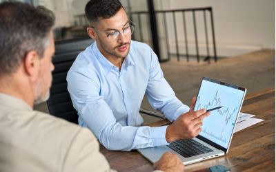 man explaining data analytics to client - Allston Yale