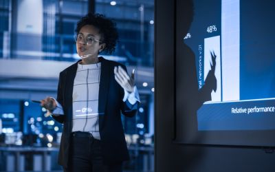 Woman presenting data analytics to business - Allston Yale